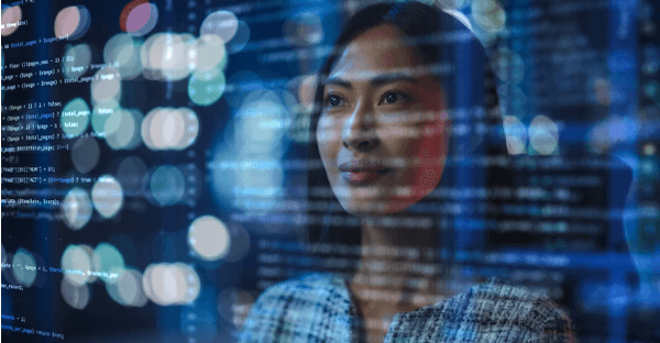 Image of woman looking at code on a screen