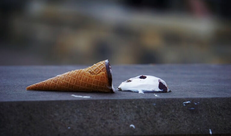 A spilled ice cream cone on pavement