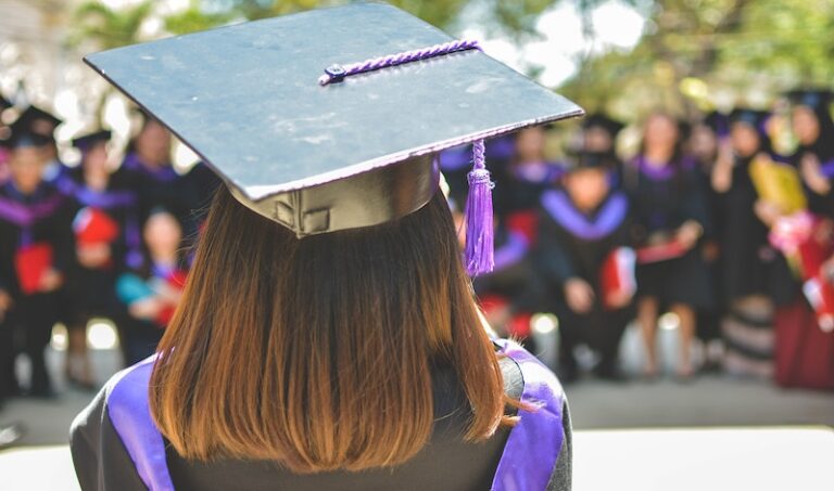 a person facing away from the camera wearing a graduation cap