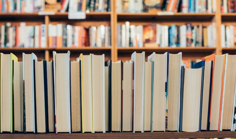 A line of books with their fore-edges showing and their spines hidden