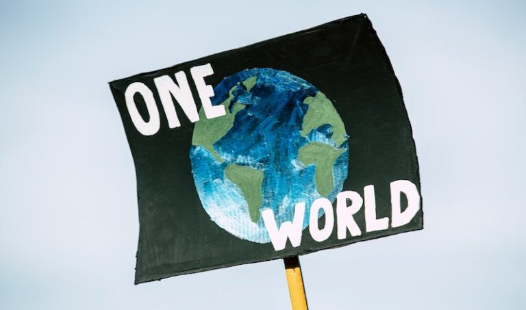a painting of planet earth with the words "one world" written across it
