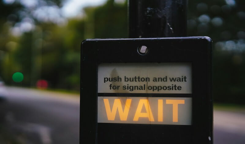 a walk signal light that says "wait"