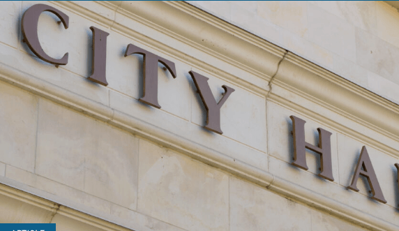 Photo of letters on a building that read "City Hall"