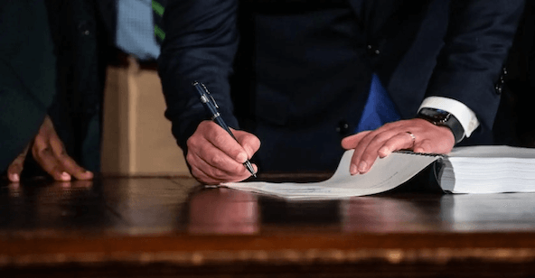 Image of someone writing on a piece of paper